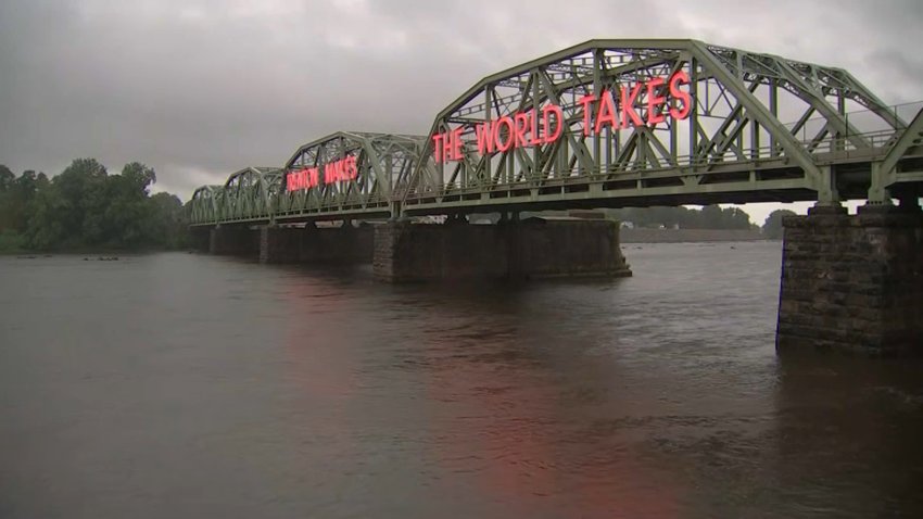 The Trenton Makes the World Takes sign is illuminated on side of bridge