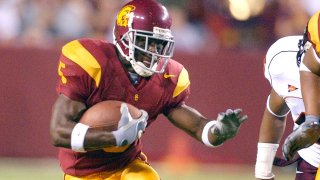 Former USC running back Reggie Bush dodges a tackle  against Virginia Tech on August 24, 2004.