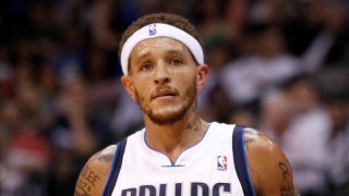 Dallas Mavericks guard Delonte West (13) talks to head coach Rick Carlisle a break in play against the Phoenix Suns in the first half of a preseason NBA basketball game Wednesday, Oct. 17, 2012, in Dallas. (AP Photo/Tony Gutierrez)