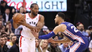 Apr 29, 2019; Toronto, Ontario, CAN; Toronto Raptors forward Kawhi Leonard (2) controls the ball as as Philadelphia 76ers forward Ben Simmons (25) defends in the third quarter in game two of the second round of the 2019 NBA Playoffs at Scotiabank Arena. Mandatory Credit: Tom Szczerbowski-USA TODAY Sports