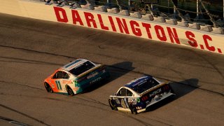 Sep 5, 2021; Darlington, South Carolina, USA; NASCAR Cup Series driver Denny Hamlin (11) leads Kevin Harvick (4) during the Cook Out Southern 500 at Darlington Raceway. Mandatory Credit: Jasen Vinlove-USA TODAY Sports