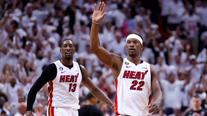 Jimmy Butler #22 and Bam Adebayo #13 of the Miami Heat react during the third quarter against the Boston Celtics in game three of the Eastern Conference Finals at Kaseya Center on May 21, 2023 in Miami, Florida.