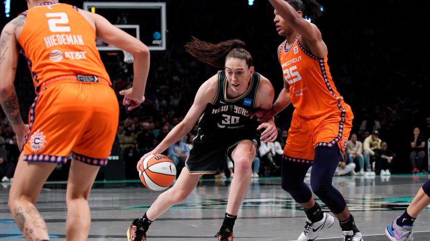 New York Liberty forward Breanna Stewart, center, drives to basket against Connecticut Sun forward Alyssa Thomas during the fourth quarter of a WNBA basketball game Sunday, Sept. 24, 2023, in New York.