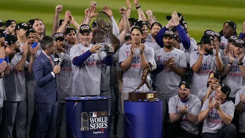 Texas Rangers manager Bruce Bochy holds up the trophy after Game 5 of the baseball World Series against the Arizona Diamondbacks Wednesday, Nov. 1, 2023, in Phoenix. The Rangers won 5-0 to win the series 4-1.