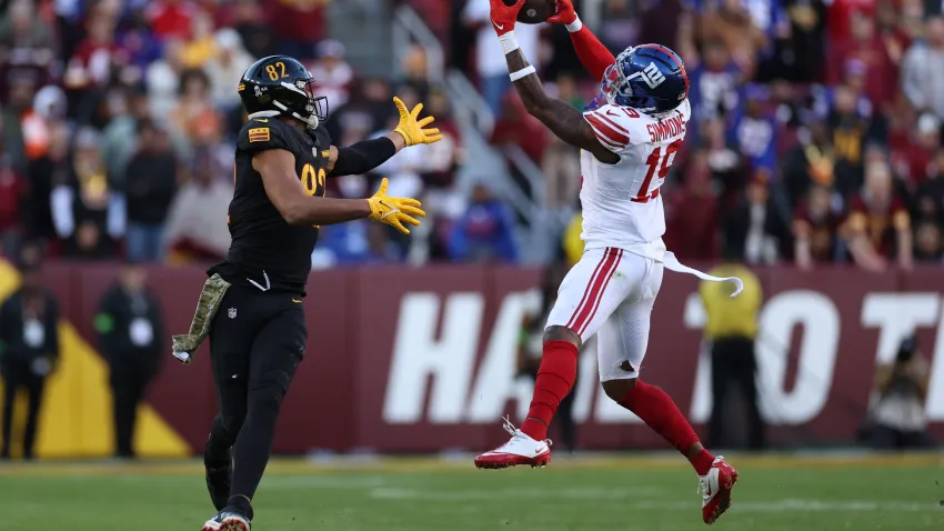 LANDOVER, MARYLAND – NOVEMBER 19: Isaiah Simmons #19 of the New York Giants makes an interceptions and returns it for a touchdown during the fourth quarter in the game against the Washington Commanders at FedExField on November 19, 2023 in Landover, Maryland. (Photo by Patrick Smith/Getty Images)