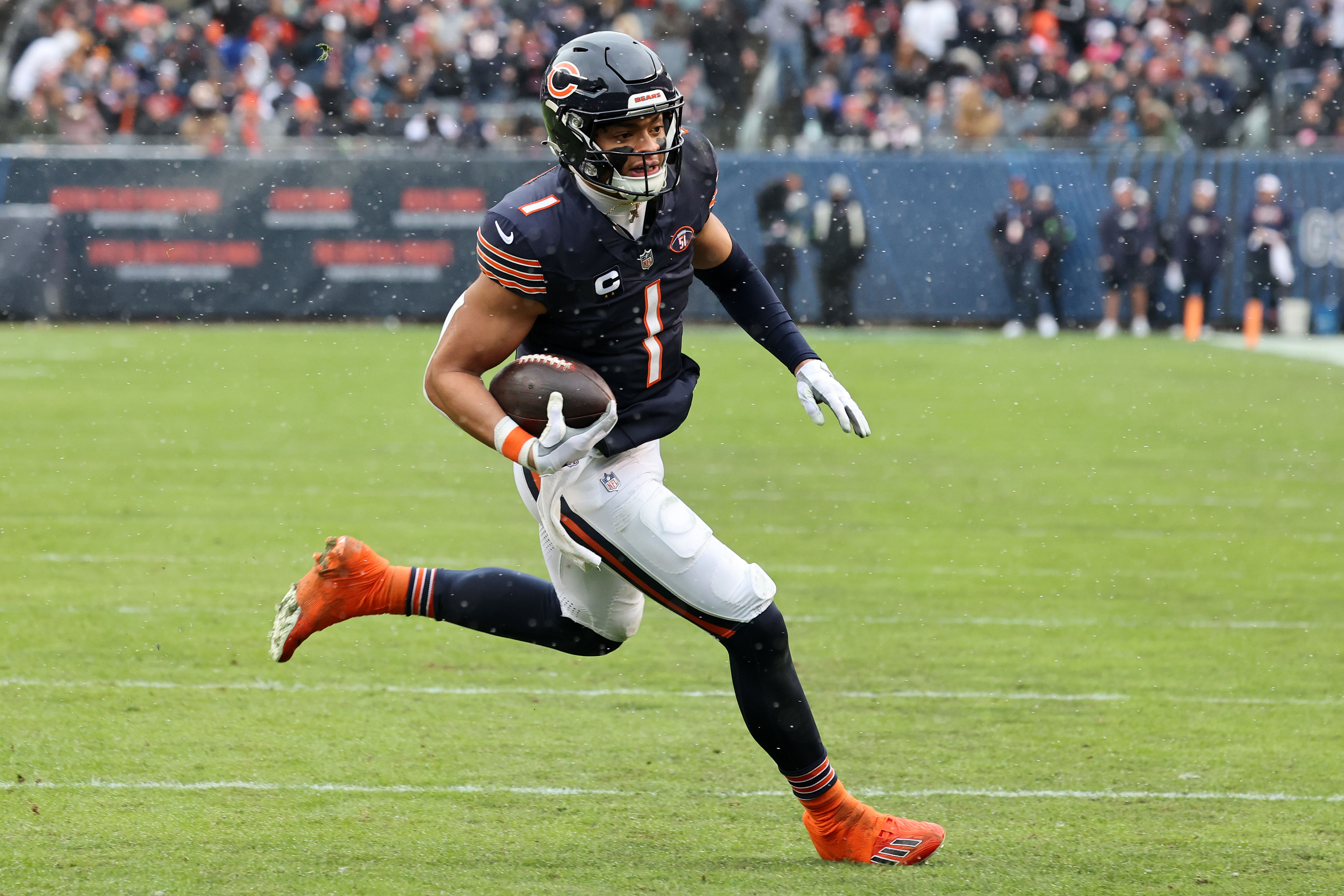 Dec 31, 2023; Chicago, Illinois, USA; Chicago Bears quarterback Justin Fields (1) rushes for a touchdown against the Atlanta Falcons during the first half at Soldier Field. Mandatory Credit: Mike Dinovo-USA TODAY Sports
