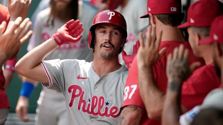 KANSAS CITY, MISSOURI – AUGUST 25: Garrett Stubbs #21 of the Philadelphia Phillies is congratulated by teammates after scoring in the third inning against the Kansas City Royals at Kauffman Stadium on August 25, 2024 in Kansas City, Missouri. (Photo by Ed Zurga/Getty Images)