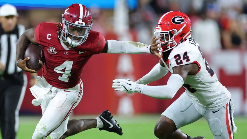 Jalen Milroe rushes the ball past Malaki Starks