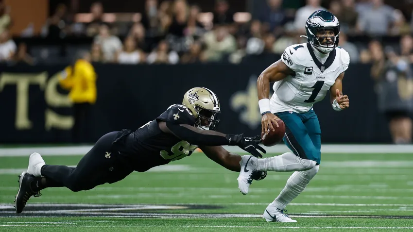 NEW ORLEANS, LOUISIANA – SEPTEMBER 22: Carl Granderson #96 of the New Orleans Saints forces a fumble against quarterback Jalen Hurts #1 of the Philadelphia Eagles during the second quarter at Caesars Superdome on September 22, 2024 in New Orleans, Louisiana. (Photo by Chris Graythen/Getty Images)