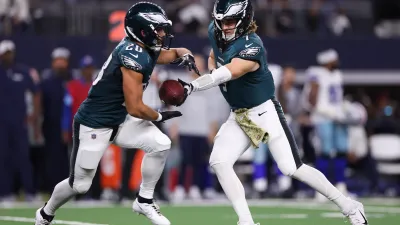 ARLINGTON, TEXAS – NOVEMBER 10: Kenny Pickett #7 hands the ball off to Will Shipley #28 of the Philadelphia Eagles during the fourth quarter against the Dallas Cowboys at AT&T Stadium on November 10, 2024 in Arlington, Texas. (Photo by Sam Hodde/Getty Images)