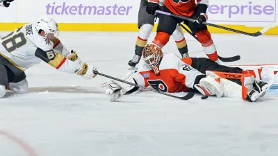 PHILADELPHIA, PENNSYLVANIA – NOVEMBER 25: Goaltender Ivan Fedotov #82 of the Philadelphia Flyers lunges across his crease to make a glove save on a scoring chance by Callahan Burke #68 of the Vegas Golden Knights at the Wells Fargo Center on November 25, 2024 in Philadelphia, Pennsylvania.  (Photo by Len Redkoles/NHLI via Getty Images)