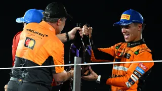 Lando Norris and Zak Brown celebrate on the podium in Abu Dhabi