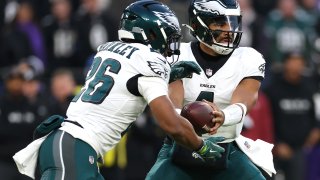 BALTIMORE, MARYLAND – DECEMBER 01: Jalen Hurts #1 of the Philadelphia Eagles hands the ball to Saquon Barkley #26 during the first quarter against the Baltimore Ravens at M&T Bank Stadium on December 01, 2024 in Baltimore, Maryland. (Photo by Patrick Smith/Getty Images)