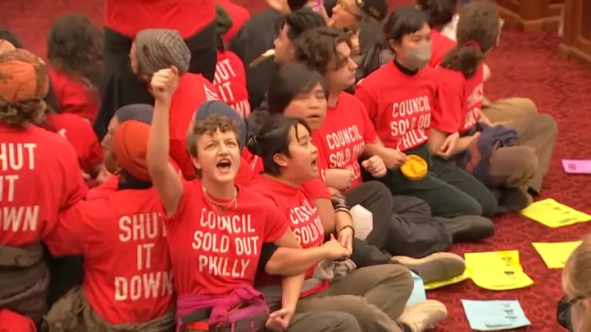 Protestors interrupt City Council's meeting where a final vote on a plan for a Sixers arena in Center City is set to be held.