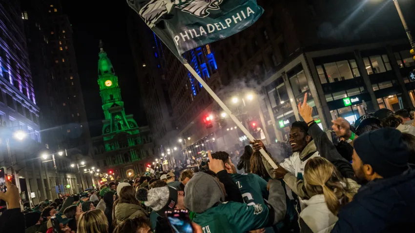 Eagles fan flies flag on crowded Broad Street.