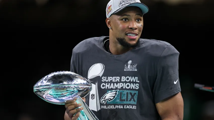 NEW ORLEANS, LOUISIANA – FEBRUARY 09: Saquon Barkley #26 of the Philadelphia Eagles holds the Vince Lombardi Trophy after winning Super Bowl LIX against the Kansas City Chiefs at Caesars Superdome on February 09, 2025 in New Orleans, Louisiana. The Eagles defeated the Chiefs 40-22. (Kara Durrette/Getty Images)