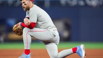 TORONTO, ON – JUNE 4: Bryce Harper #3 of the Philadelphia Phillies kneels in a break in play against the Toronto Blue Jays in their MLB game at the Rogers Centre on June 4, 2025 in Toronto, Ontario, Canada. (Photo by Mark Blinch/Getty Images)