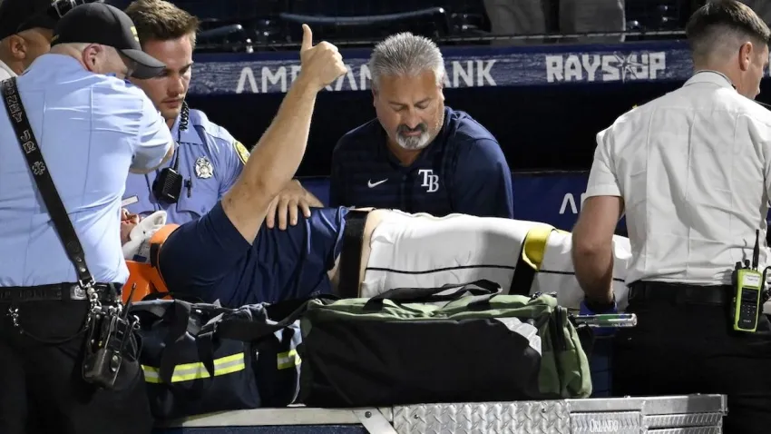 Tampa Bay Rays’ Hunter Bigge gives a thumbs up as paramedics tend to him after being hit by a foul ball while in the dugout during the seventh inning of a baseball game against the Baltimore Orioles, Thursday, June 19, 2025, in Tampa, Fla. (AP Photo/Jason Behnken)