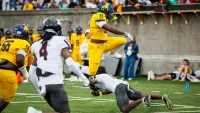 Johnson C. Smith running back Kamarro Edmonds hurdles over Morehouse defensive back Carlos Dunovant