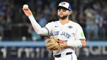 Oct 24, 2025; Toronto, Ontario, CAN; Toronto Blue Jays second baseman Bo Bichette (11) makes a play to get out Los Angeles Dodgers first baseman Freddie Freeman (not pictured) in the first inning during game one of the 2025 MLB World Series at Rogers Centre. Mandatory Credit: Dan Hamilton-Imagn Images