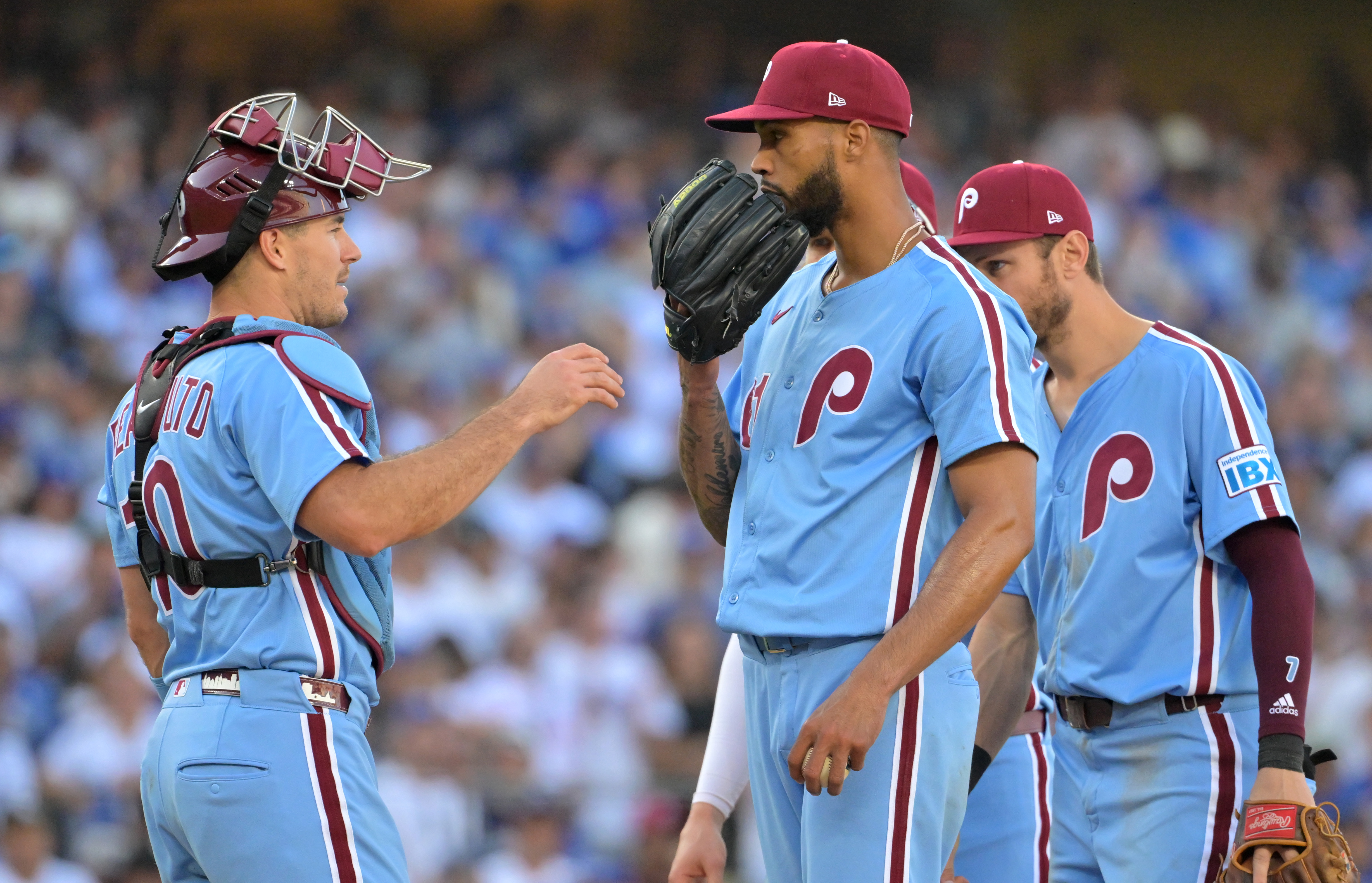 Oct 9, 2025; Los Angeles, California, USA; Philadelphia Phillies catcher J.T. Realmuto (10) talks to pitcher Cristopher Sanchez (61) in the sixth inning against the Los Angeles Dodgers during game four of the NLDS round for the 2025 MLB playoffs at Dodger Stadium. Mandatory Credit: Jayne Kamin-Oncea-Imagn Images