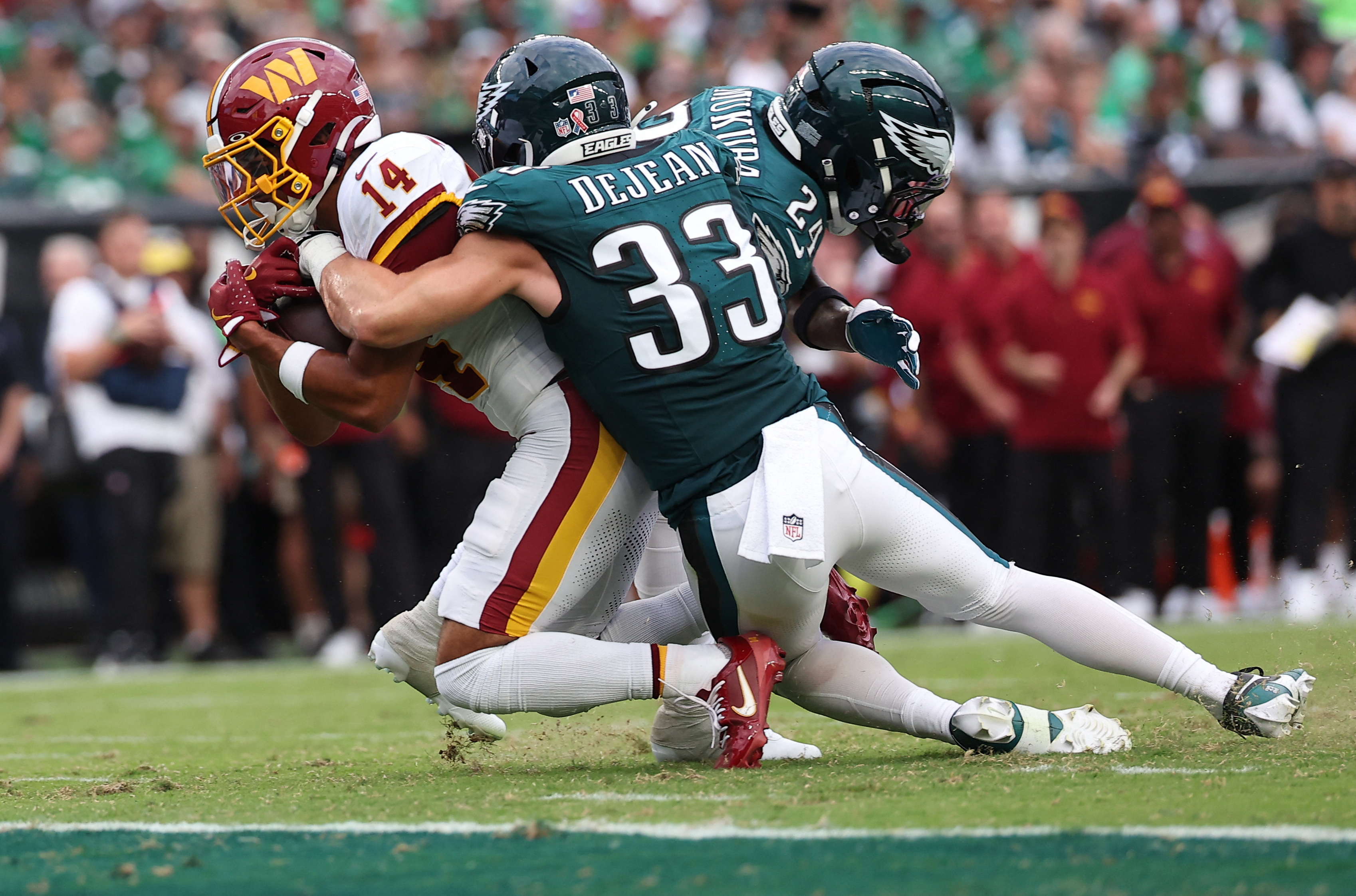 Sep 13, 2026; Philadelphia, Pennsylvania, USA;  Washington Commanders wide receiver Antonio Williams (14) carries the ball against Philadelphia Eagles defensive back Cooper DeJean (33) during the first half at Lincoln Financial Field.  Mandatory Credit: Bill Streicher-Imagn Images