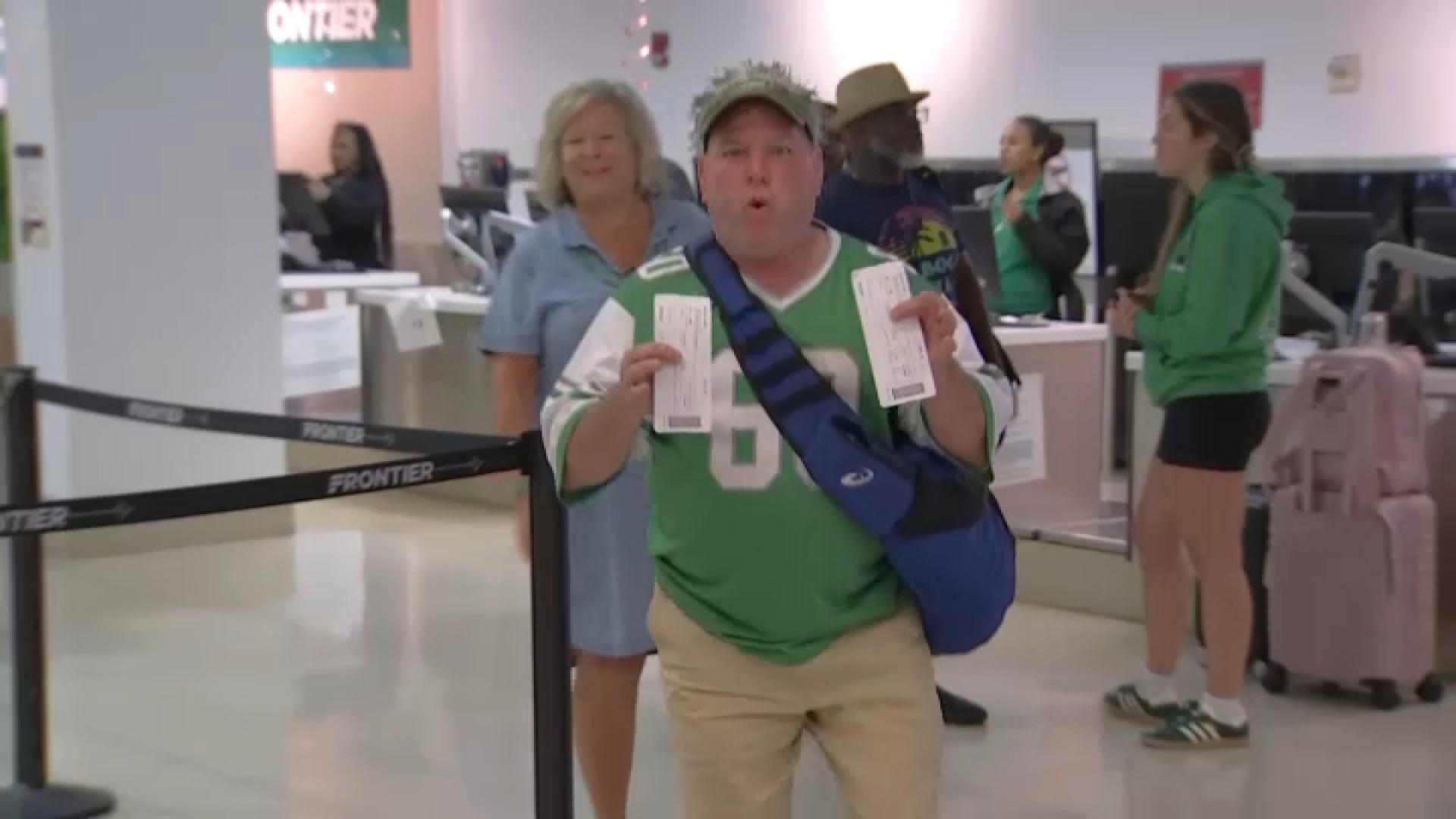 Eagles fan Paul Edwards from Quakertown displays his tickets at the Philadelphia International Airport as he heads to Tennessee for Sunday's game.